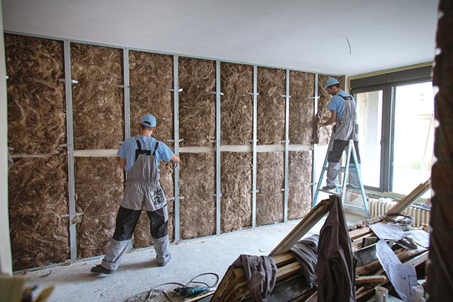 A two people of a construction crew working on a house