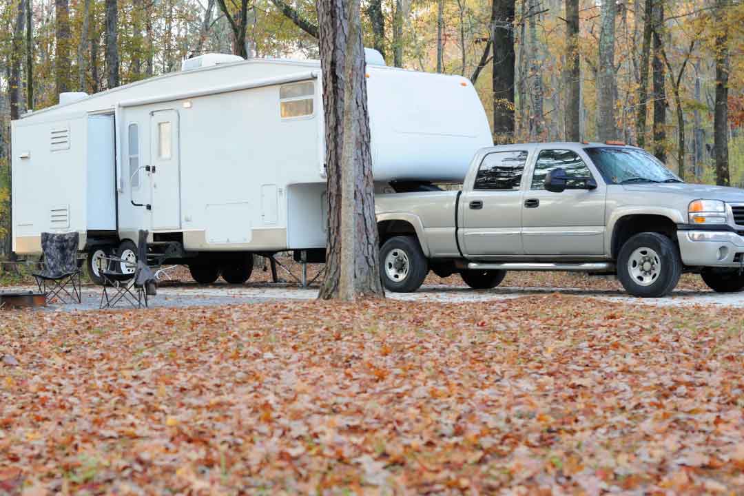 A truck with 5th wheel attachment pulling a 5th wheel trailer